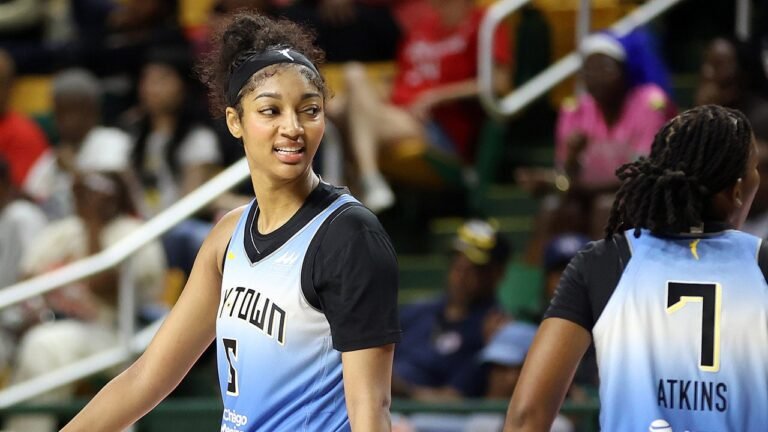 Sky star Angel Reese reacts after slapping clipboard out of coach's hand