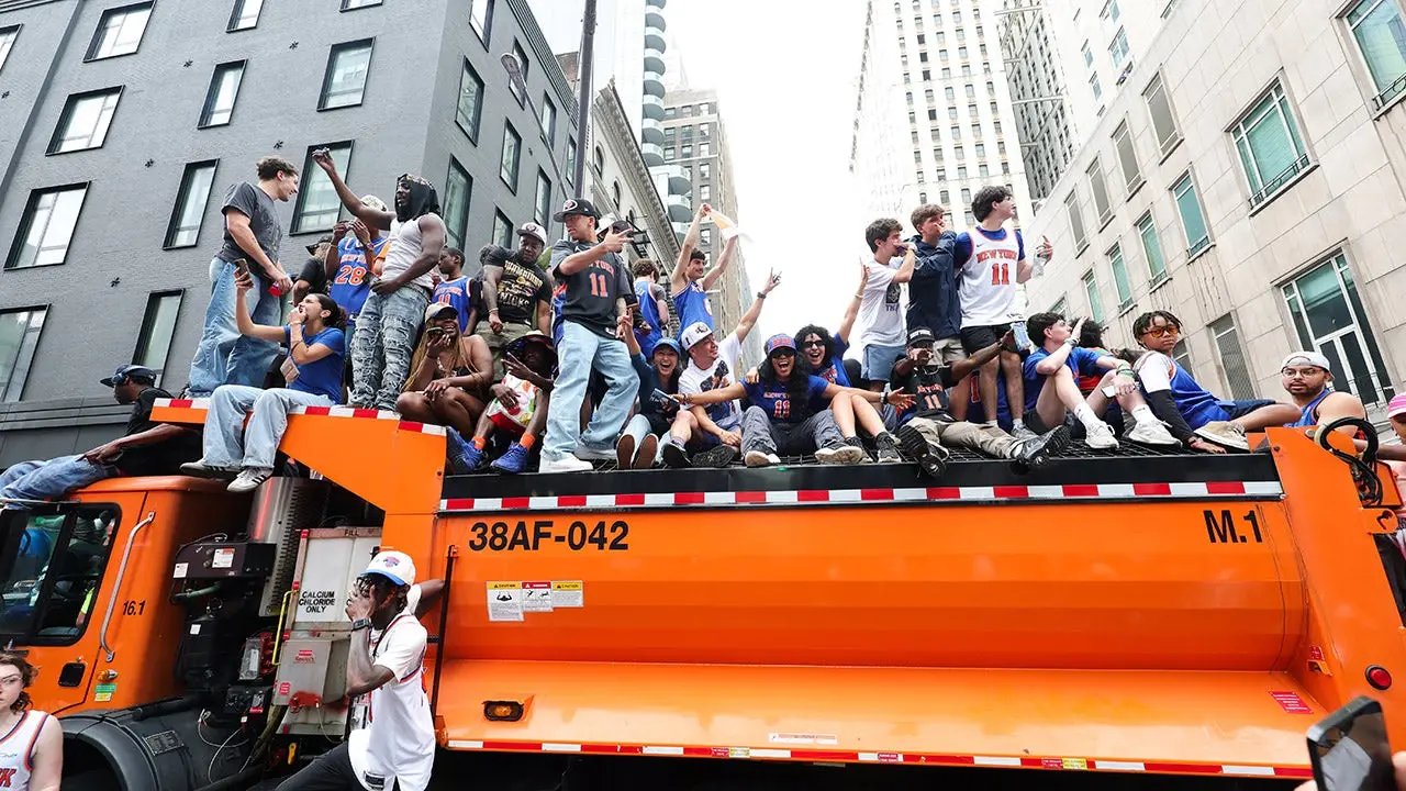 Knicks fans climb on police cars, sanitation trucks as countless others unable to get into jam-packed parade